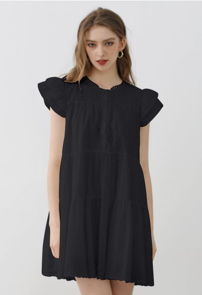 فستان دوللي ميني مطرز بزهرة جميلة باللون الأسود