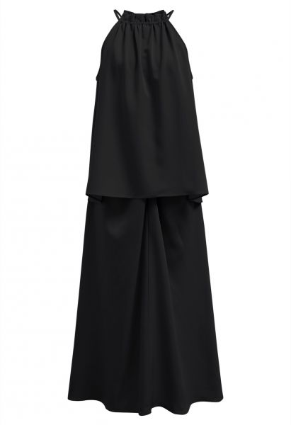 طقم تنورة طويلة بحمالة علوية مكشكشة وتنورة أمامية ملتوية باللون الأسود