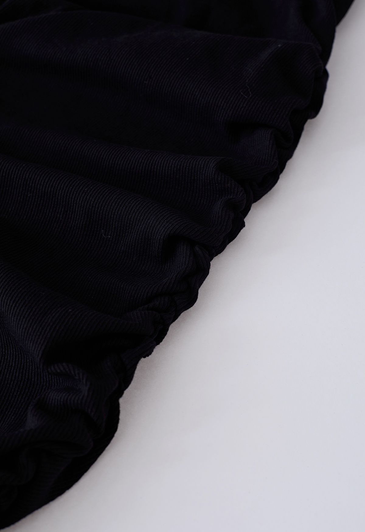 فستان أسود سادة بدون أكمام مزين بكشكشة