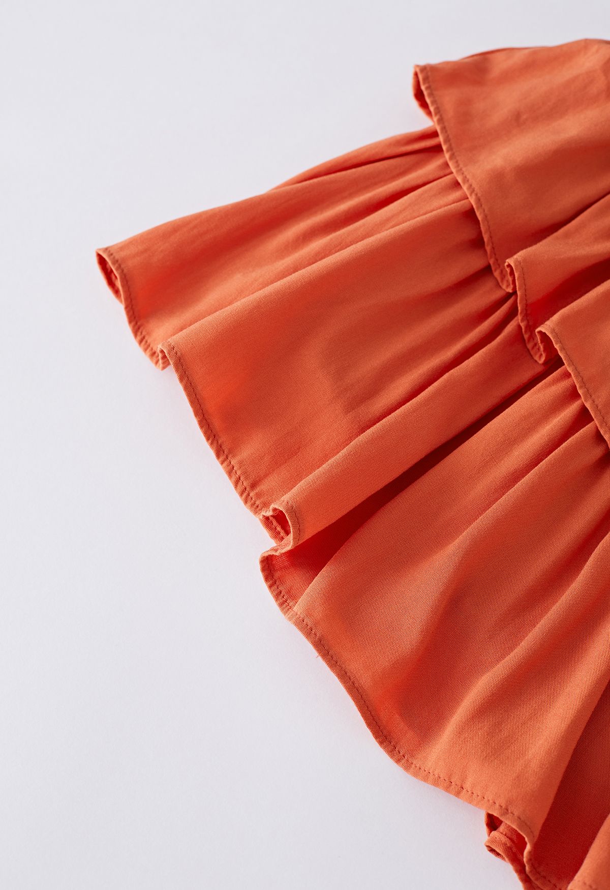 تنورة قصيرة مكشكشة متدرجة الخصر باللون البرتقالي