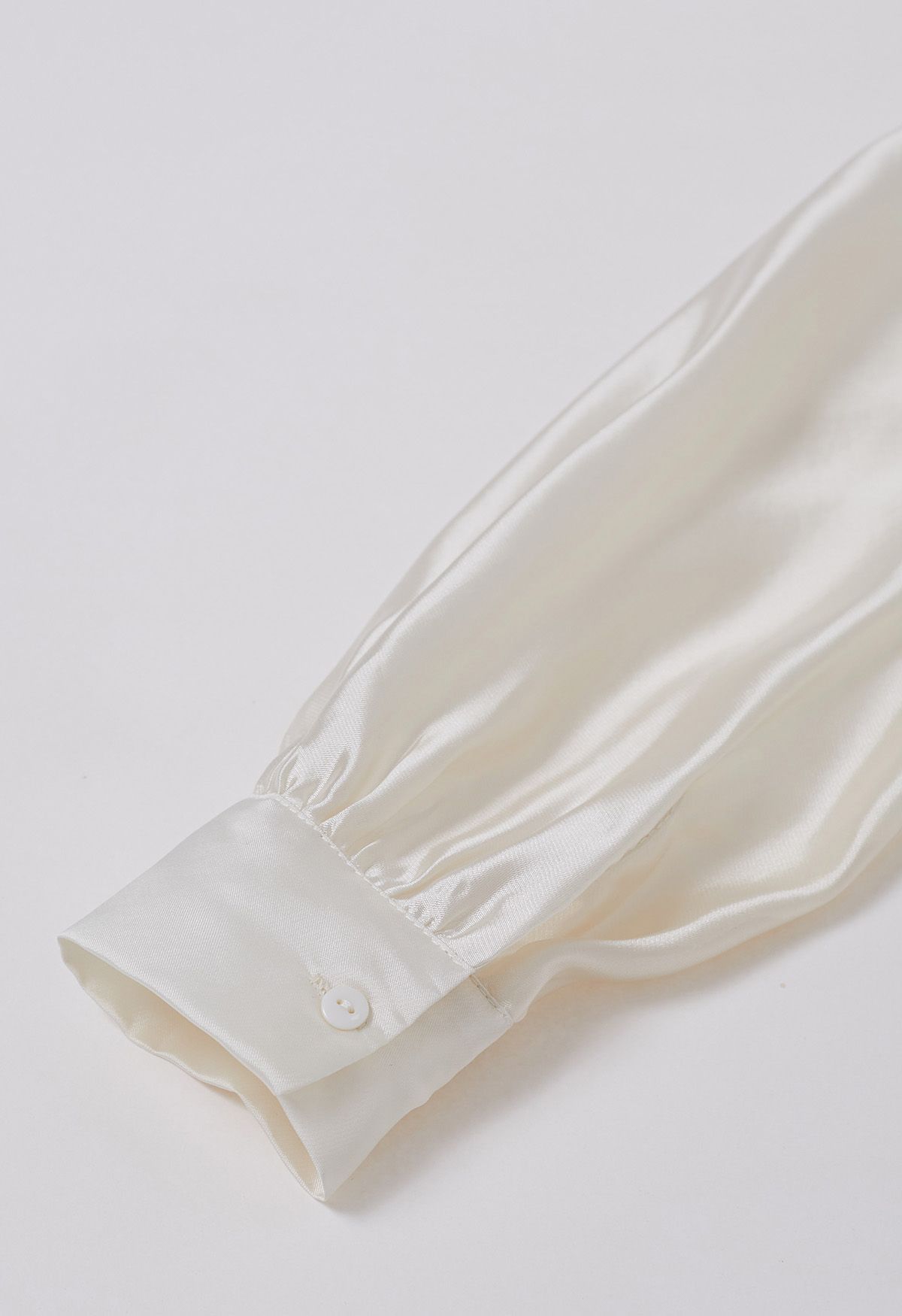 قميص شفاف بأكمام منفوخة وعقدة أنيقة باللون الكريمي