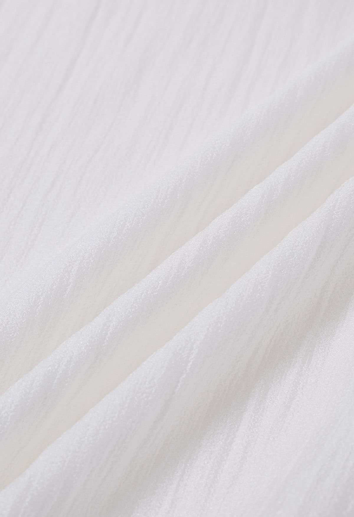 بلوزة شفافة ذات ربطة عنق جانبية باللون الأبيض