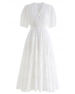 فستان متوسط الطول بياقة على شكل V ومربعات باللون الأبيض
